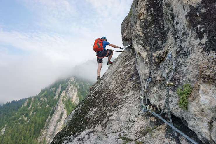 Climber scaling a mountain
